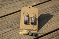 Duck feather rectangle earrings styled on a rustic weathered wood surface