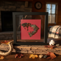 SC Gamecock in-state feather art displayed in rustic barn wood setting