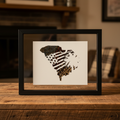 South Carolina feathered silhouette art displayed on rustic wood background