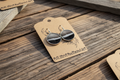 Duck feather circle earrings styled on a rustic weathered wood surface